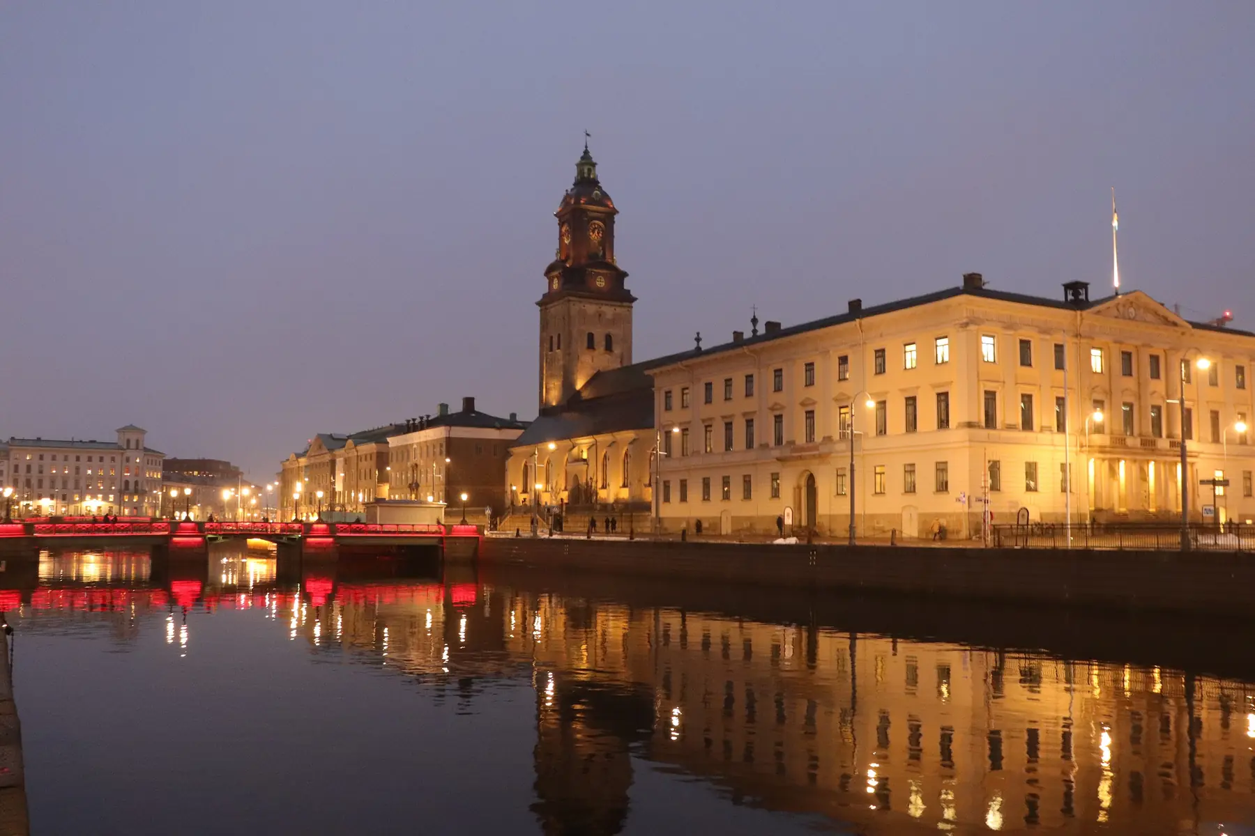 Stora Hamnkanalen i Göteborg i aftenlys med oplyste bygninger og Tyska kyrkans tårn